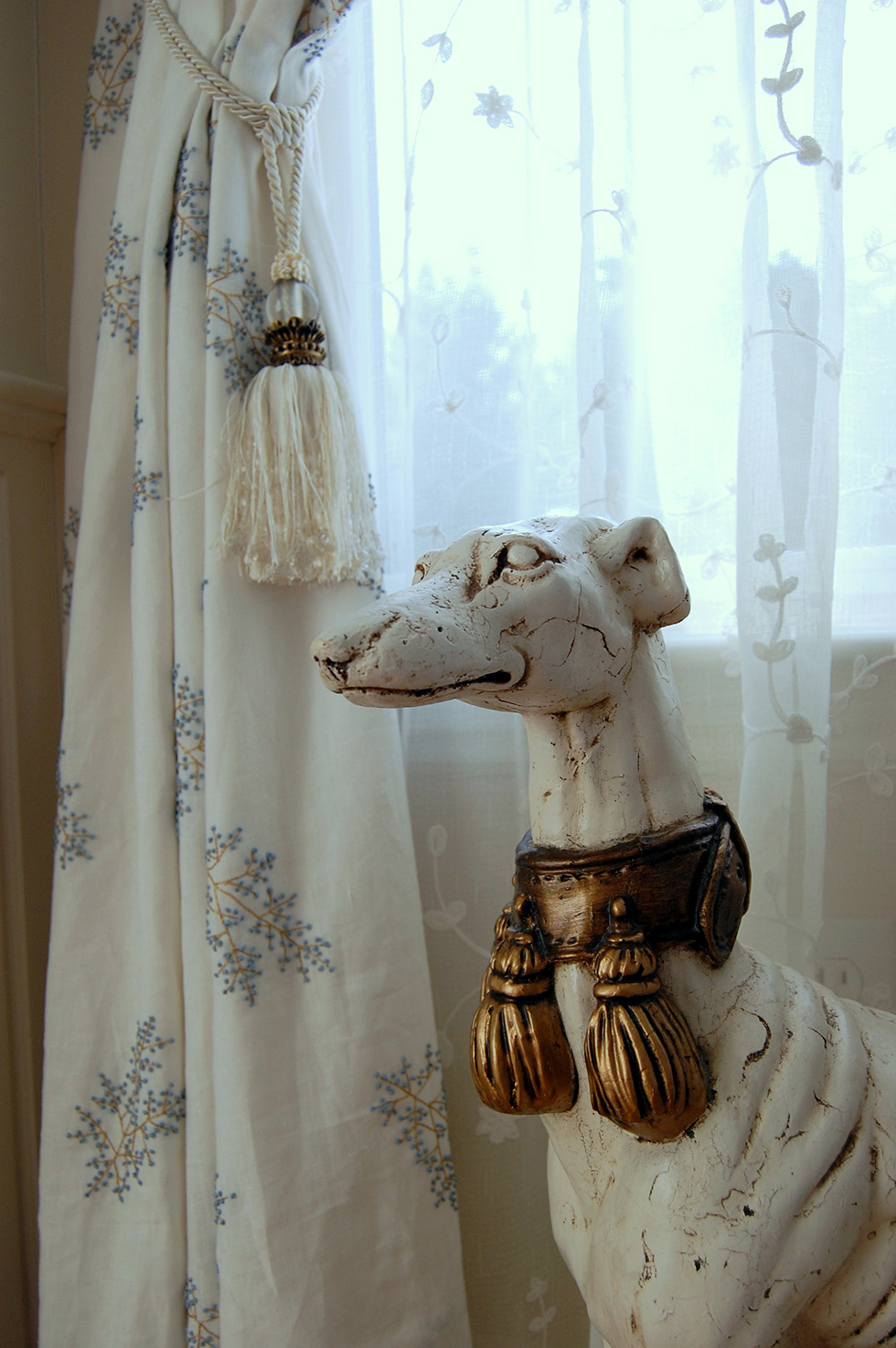 dog statue by curtain